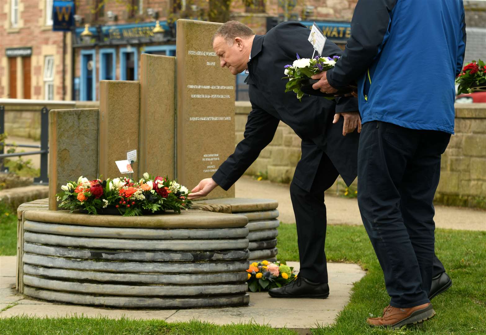 Inverness MP Drew Hendry places a wreath on the memorial.