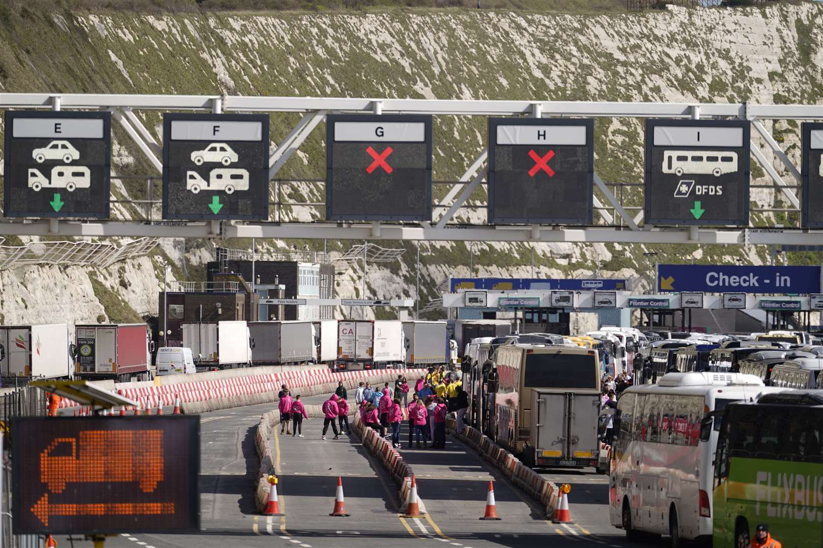 Passengers wait beside coaches queuing to enter the Port of Dover in Kent on Sunday (Andrew Matthews/PA)