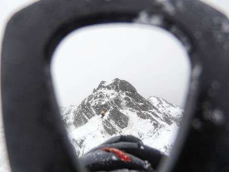 Looking through the adze of John’s ice-axe to Peter below the higher east summit.