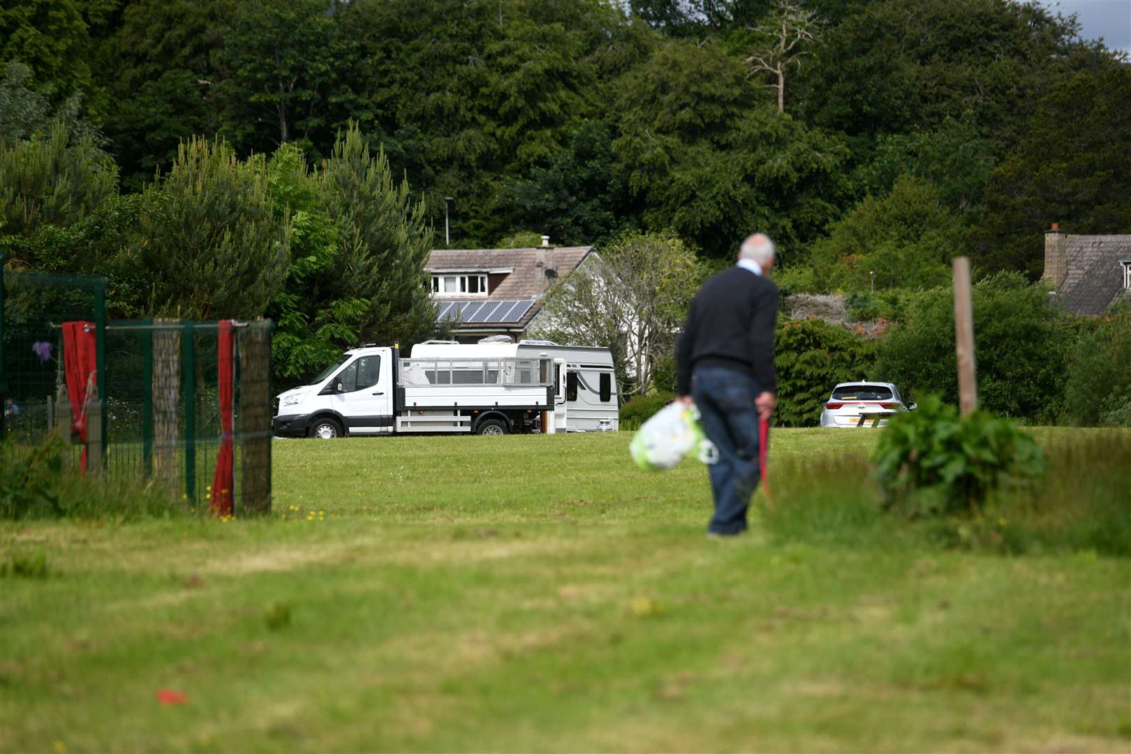 Man looking at Travellers' camp near the Gaelic School.