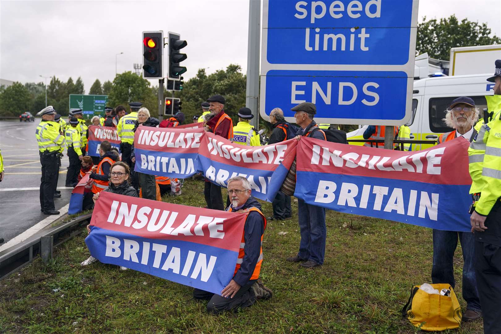 Members of Insulate Britain occupying a roundabout leading from the M25 motorway to Heathrow Airport in London (Steve Parsons/PA)
