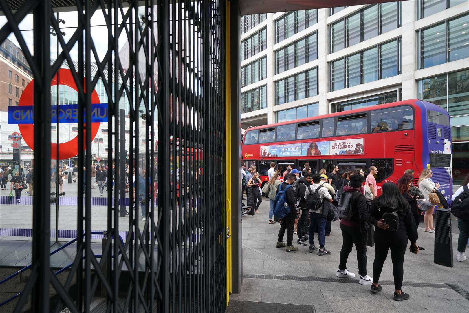 People waiting for a bus outside Victoria Station, central London (Kirsty O’Connor/PA)