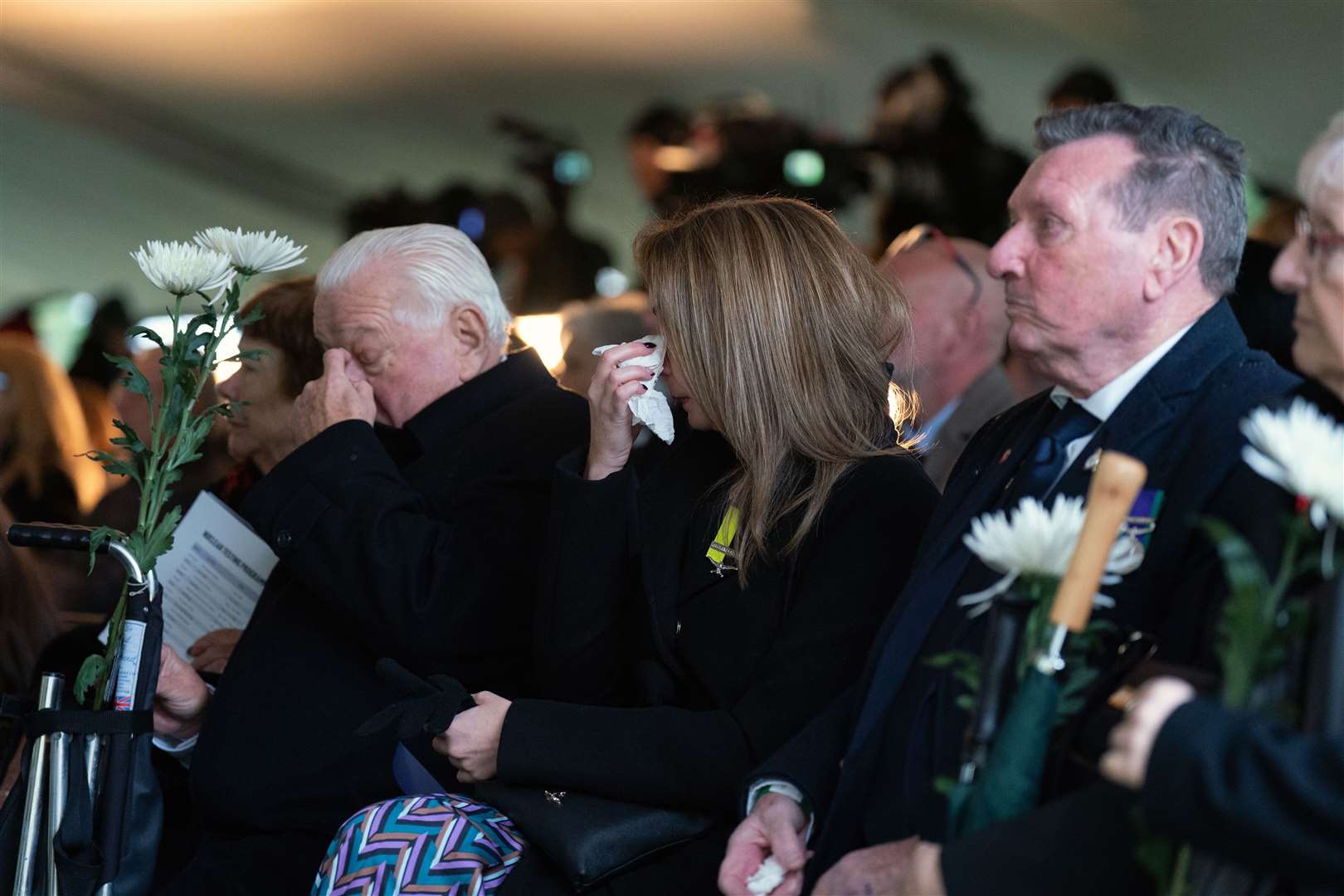 Laura Morris (centre), whose grandfather John Morris is an atom bomb test veteran reacts to the medal announcement, alongside veterans Ed McGrath (left) and Eric Barton (right) (Joe Giddens/PA)
