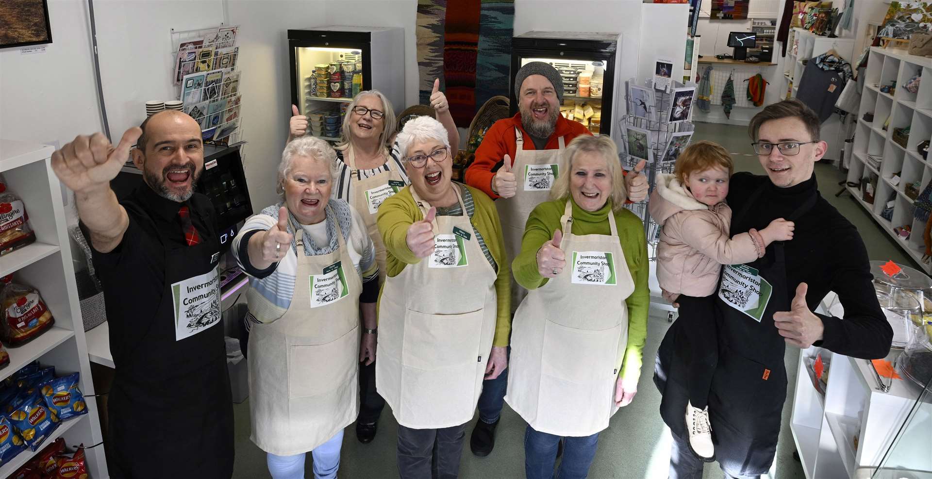Celebrations from the team who will be running the Invermoriston Community Shop (left - right) Stephane Pilli , Stella Barter, Jackie Buckley, Hilary Wilson, Paul McIntosh, Lynne West and Julius Prakelis with his daughter, Renesme.