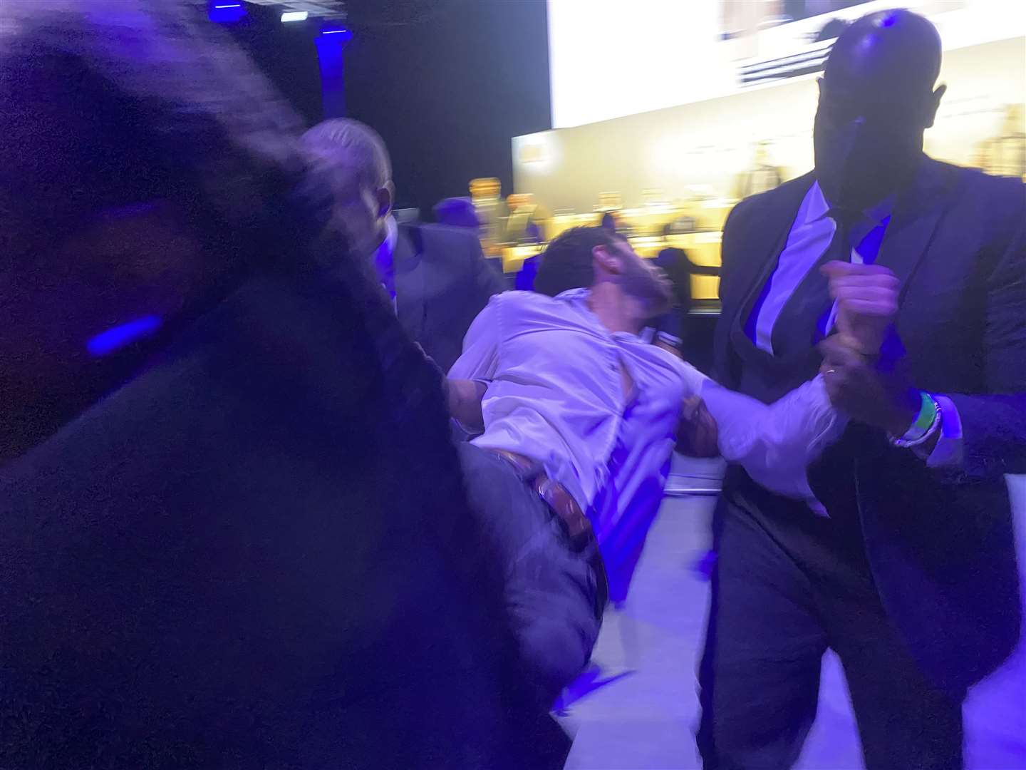 Protesters were carried out of the meeting room at the Excel conference centre (Rebecca Speare-Cole/PA)