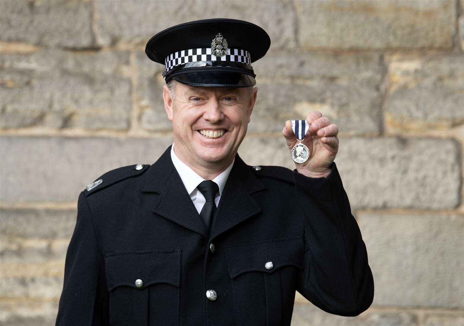 Pc Stephen Tanner after receiving the Queen’s Police Medal (Lesley Martin/PA)