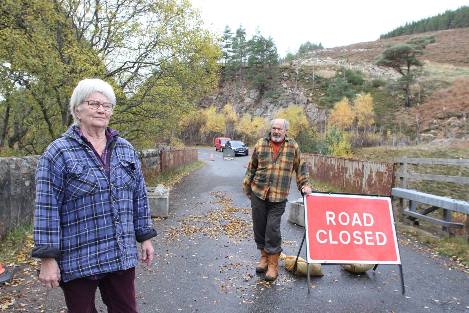 Local residents Liz and Ian Bishop at the blocked off approach to Sloch Cottages Bridge at the time of its closure a year ago.