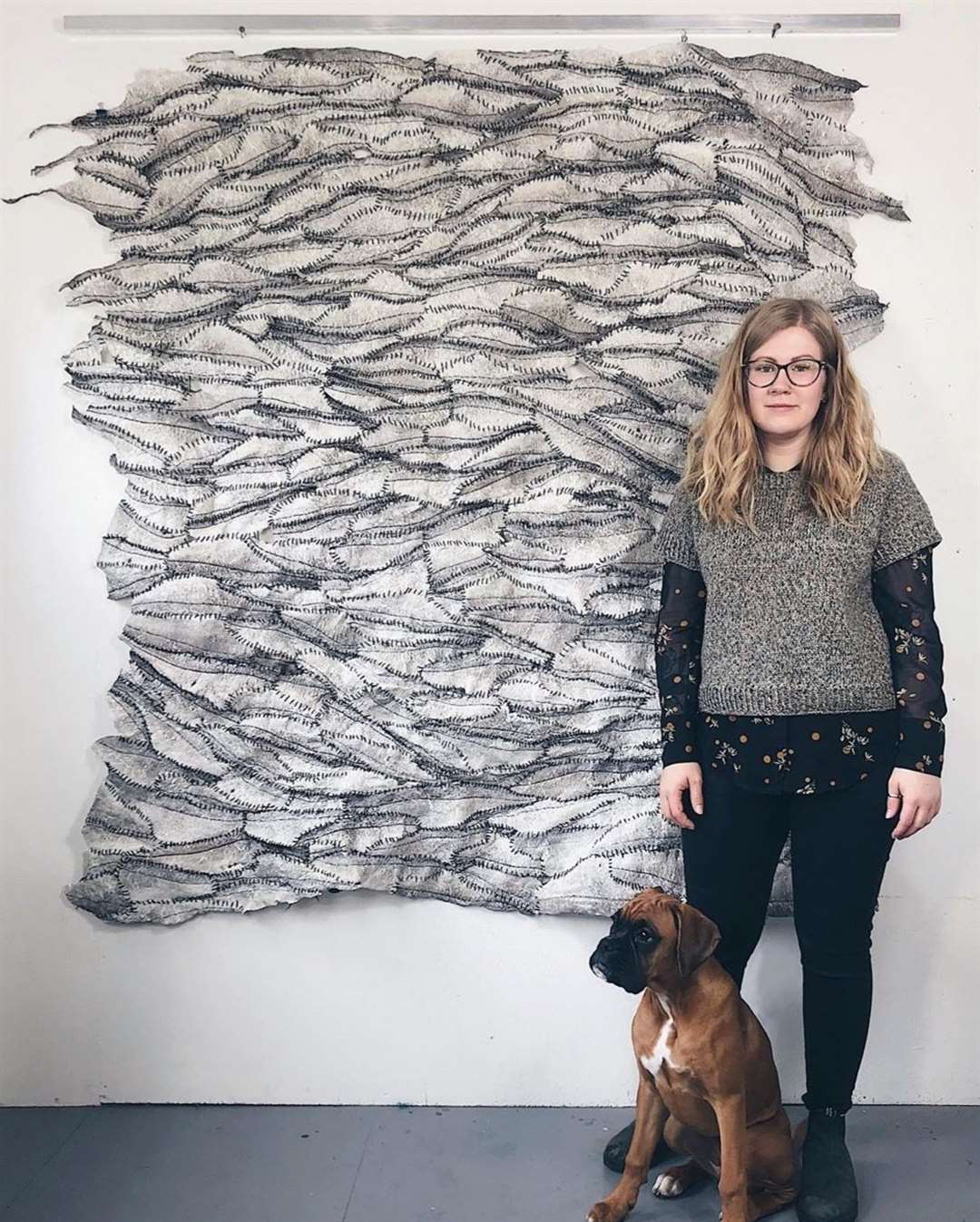 Artist Vivian Ross-Smith with Network, made of haddock skins stitched together with Shetland wool.