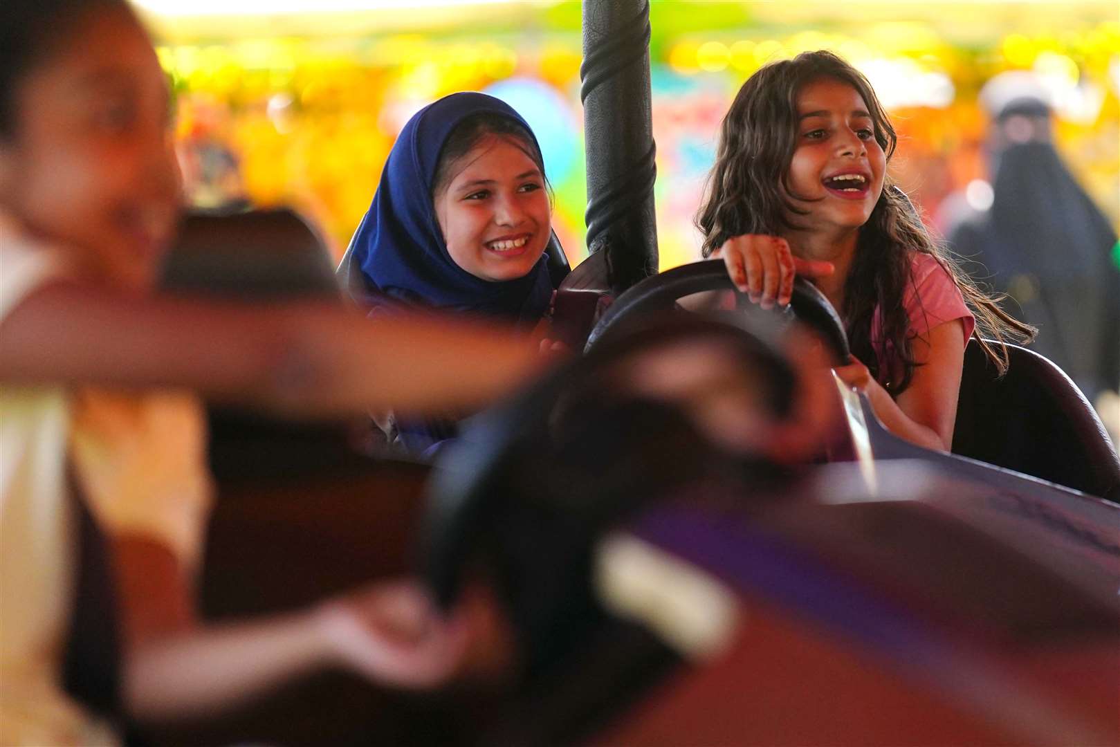 Children on bumper cars during Eid al-Adha (Victoria Jones/PA)