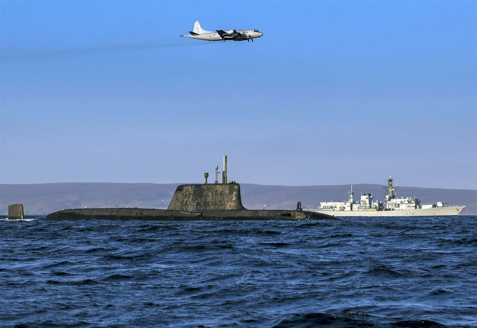 Joint Warrior - Biannual NATO Exercise. An Astute class nuclear submarine in company with the Type 23 frigate HMS Kent being over flown by a German Navy P3 maritime patrol aircraft.