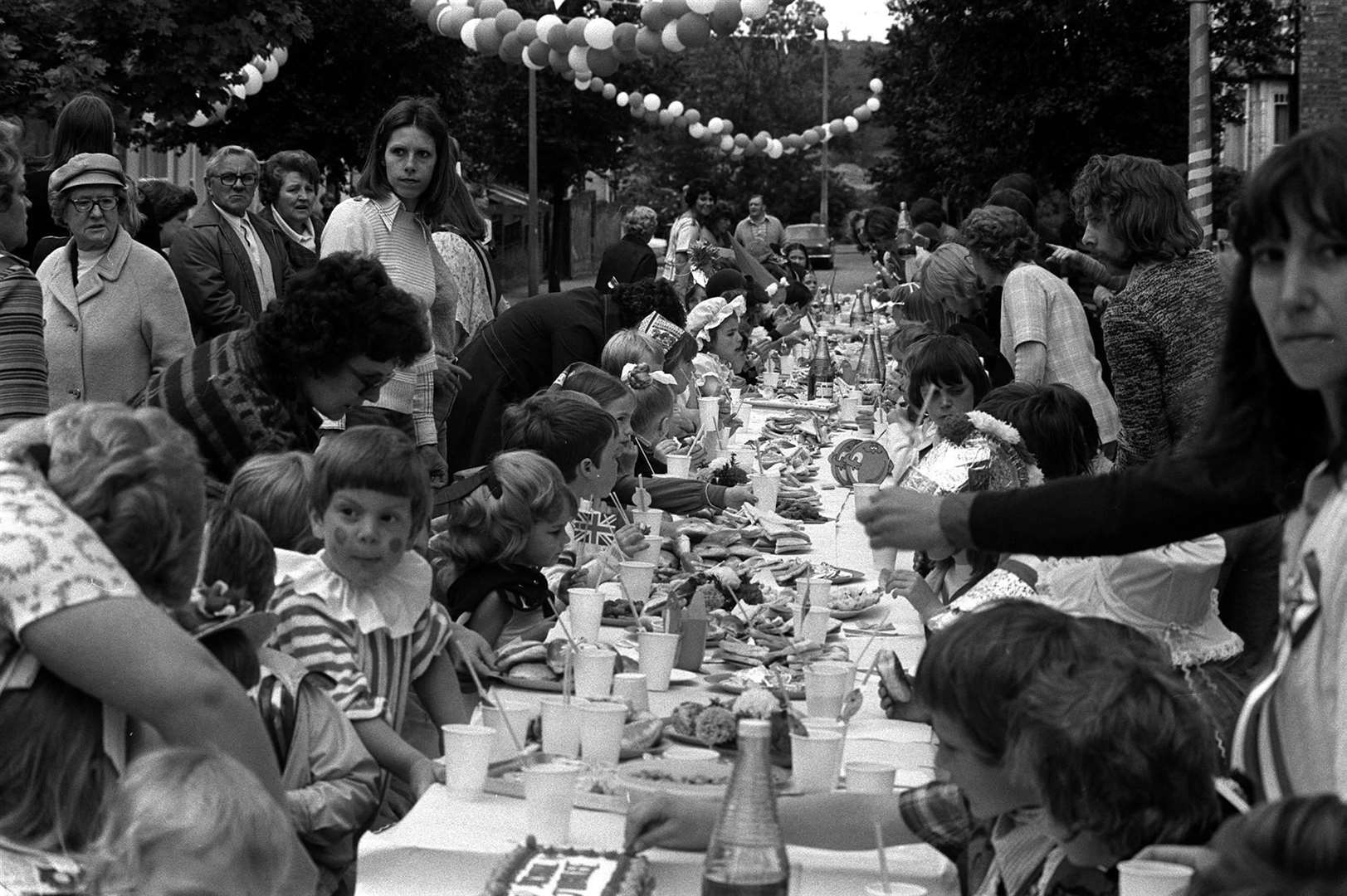 Residents of Woodford Bridge, Essex, celebrate the Queen’s Silver Jubilee with a street party for local children in 1977 (PA)
