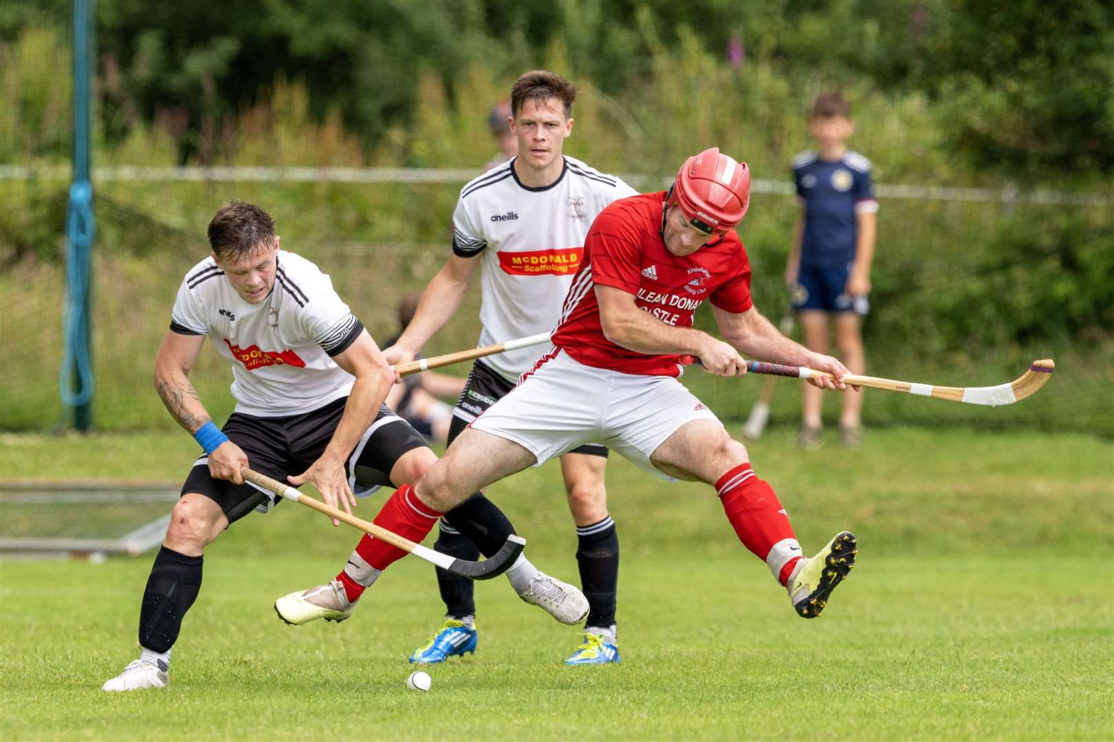 Kinlochshiel's Keith Macrae (right) against Lovat's Mainland brothers, Martin (left) and Craig. Kinlochshiel v Lovat in the Artemis MacAulay Cup quarter final, played at Rearaig, Balmacara.
