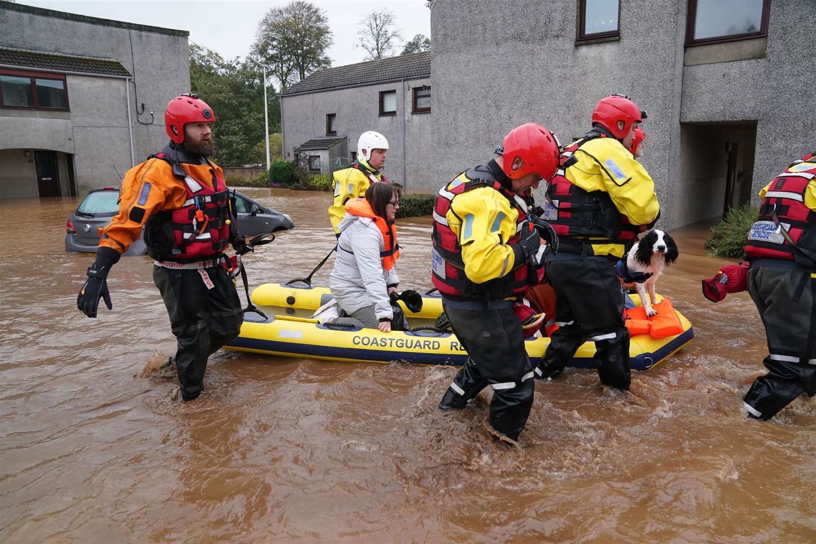 Members of the emergency services help local residents to safety in Brechin (Andrew Milligan/PA)
