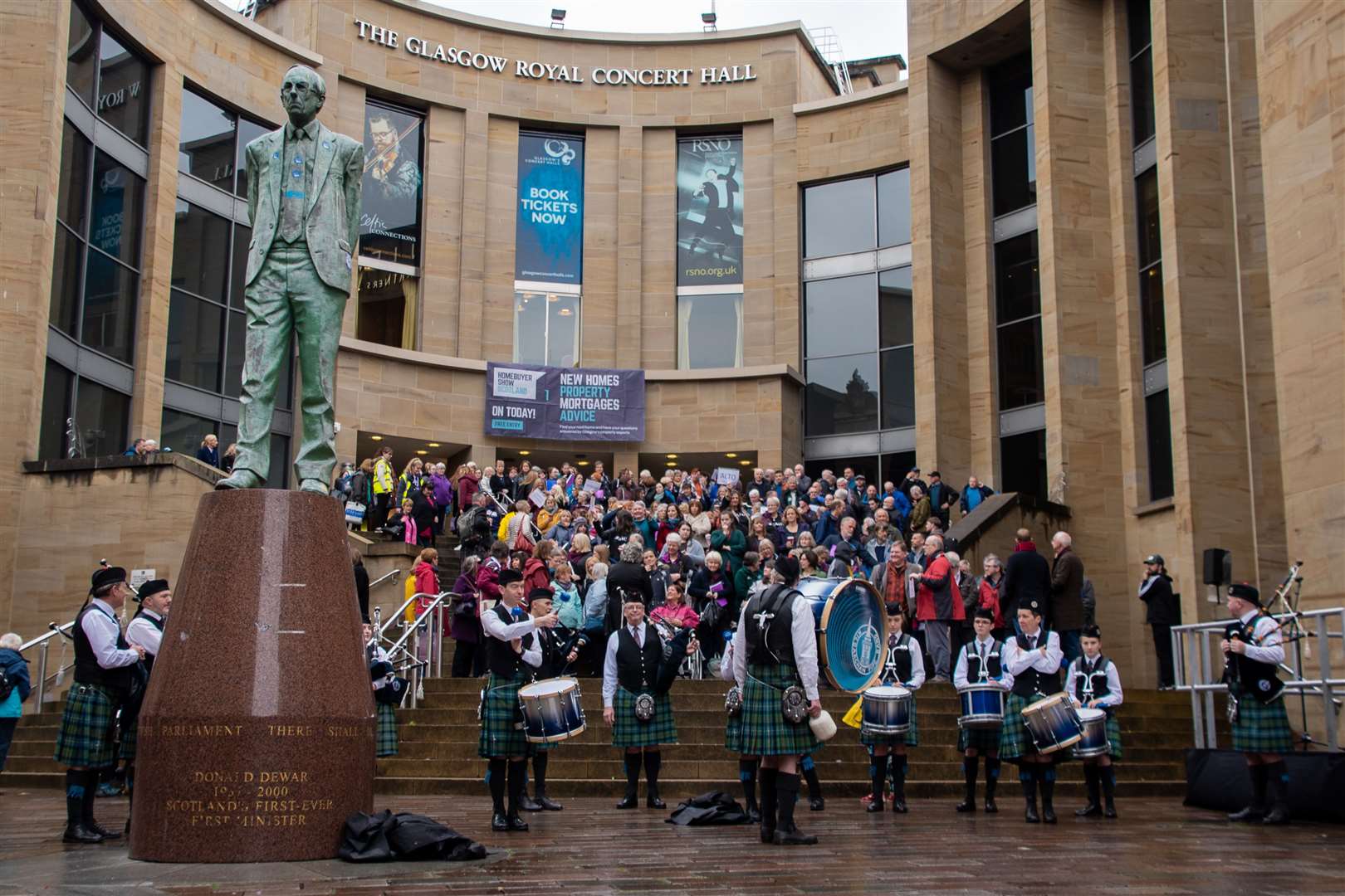 Choirs competing at the Royal National Mòd gather on the steps of the Royal Concert Hall in Glasgow for one final performance.