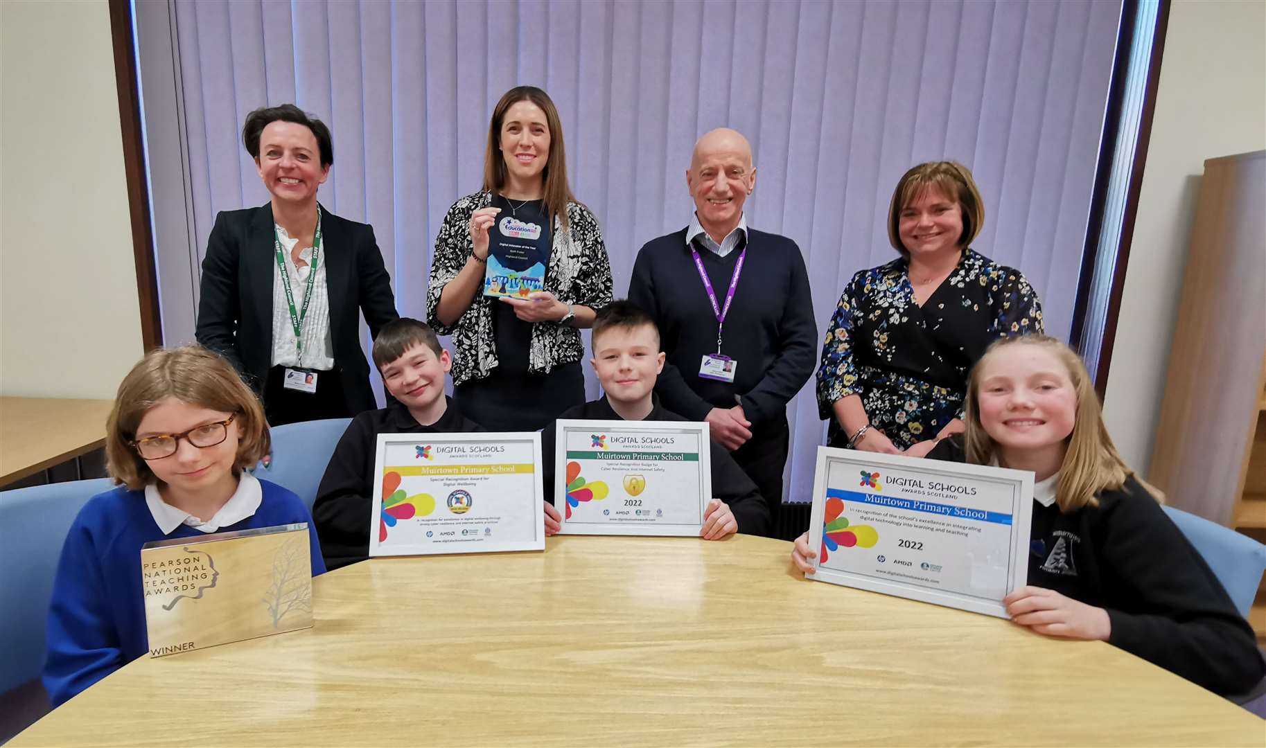 Back row, from left: Highland Council education boss Nicky Grant, teacher Beth Fuller, education committee chairman John Finlayson and head teacher Janice MacRae, with (front row) Muirtown Primary pupils proudly showing off their school’s digital awards.