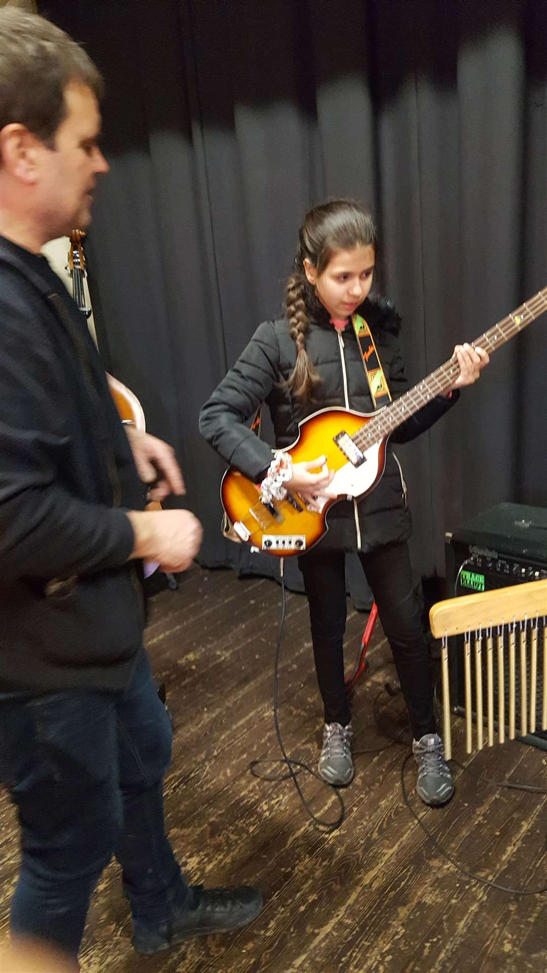 Getting to grips with a bass guitar.