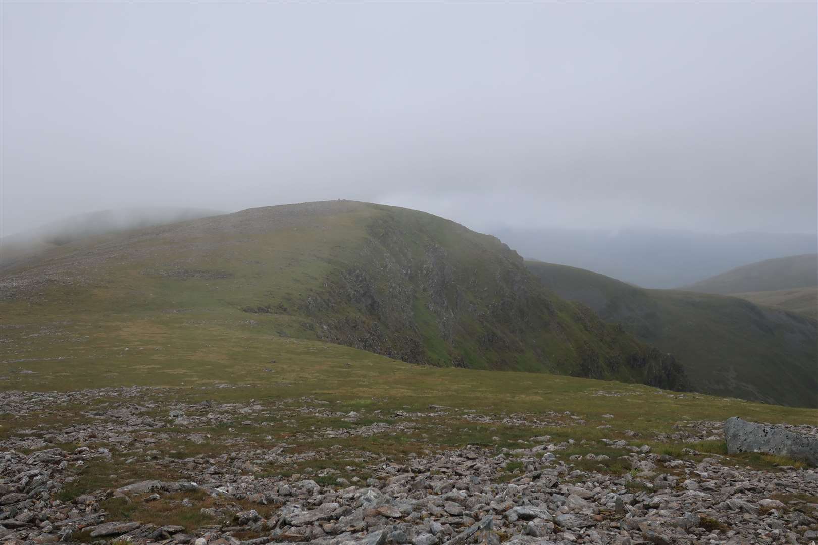 A glimpse of Beinn a'Chaorainn's summit as the cloud blows over.