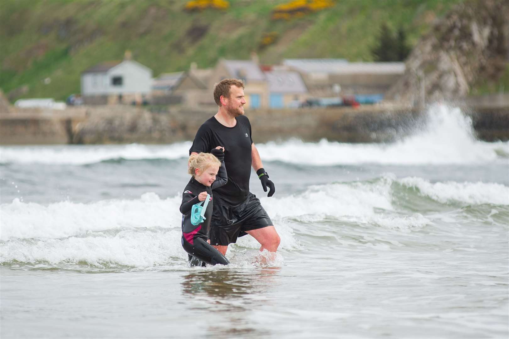 Mike and daughter Charlotte go wild swimmng at Cullen. Picture: Daniel Forsyth