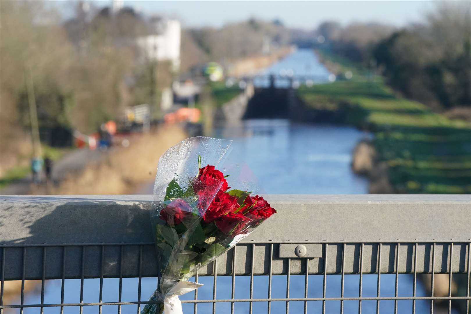A bunch of red roses placed on the bridge across the Grand Canal in Tullamore, Co Offaly (Niall Carson/PA)