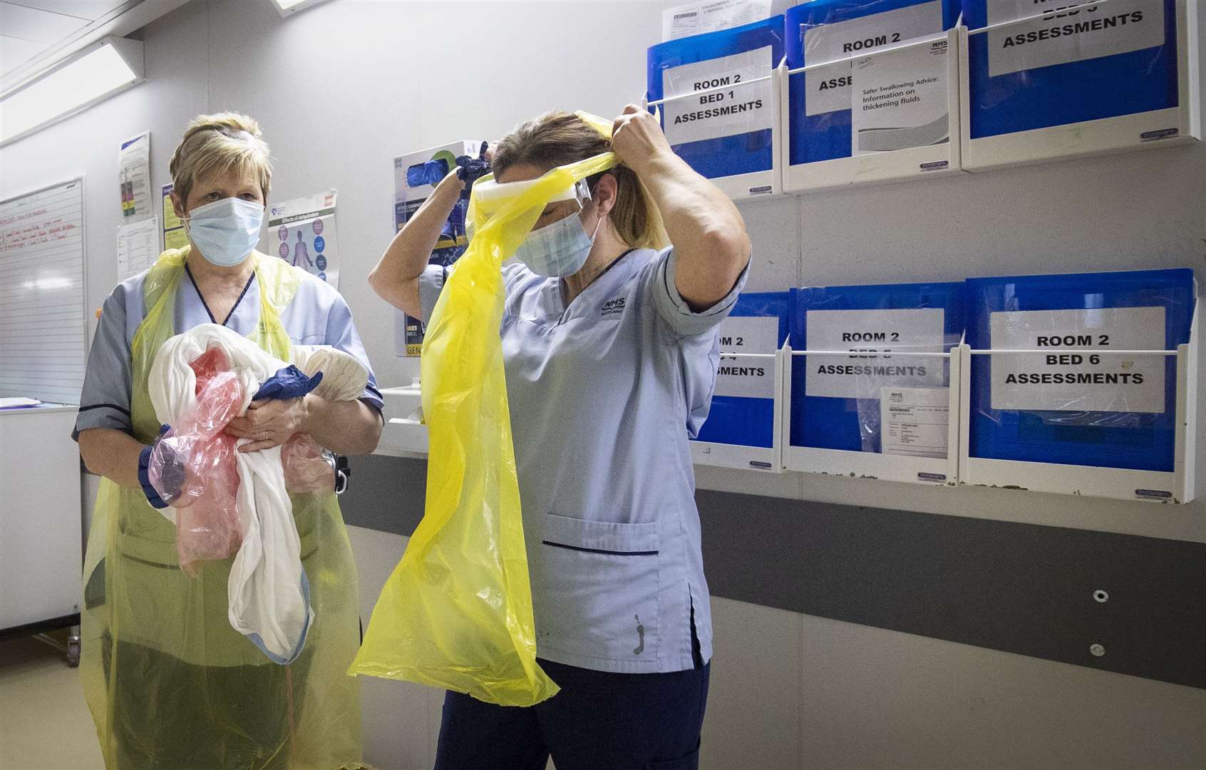 Nurses changing their PPE (Jane Barlow/PA)