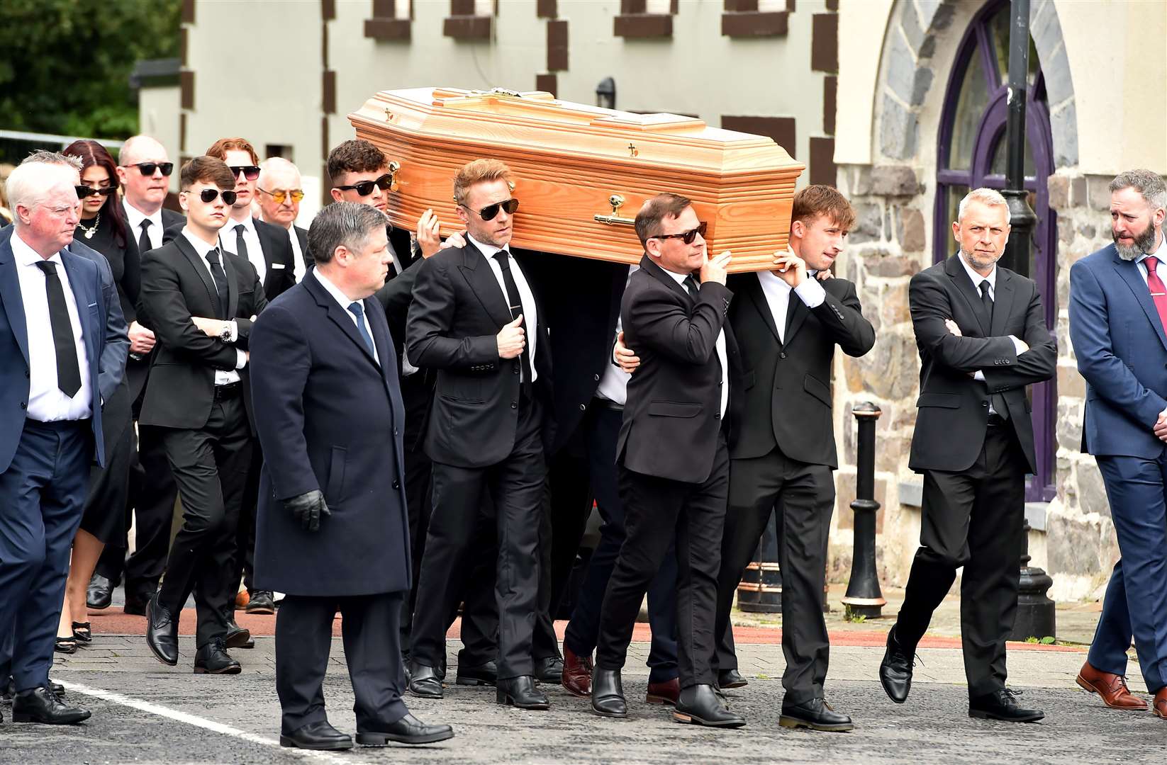 Ronan Keating (centre middle left) helps carry the coffin of his brother Ciaran towards St Patrick’s Church in Louisburgh, Co Mayo (Oliver McVeigh/PA)
