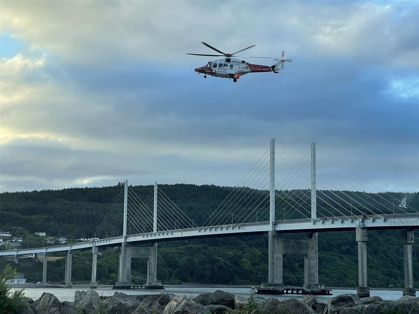 The helicopter hovering above the water near the Kessock Bridge during the search on Tuesday evening.