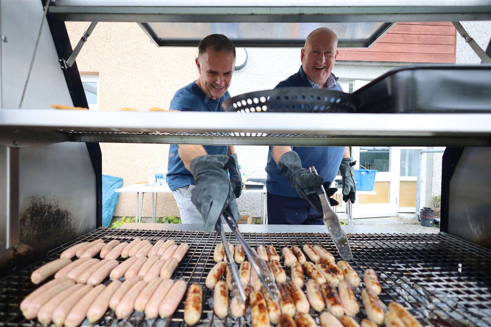Willie Matheson and Iain Maclelland cook a barbecue lunch for the hard-working volunteers. Picture: James Mackenzie.