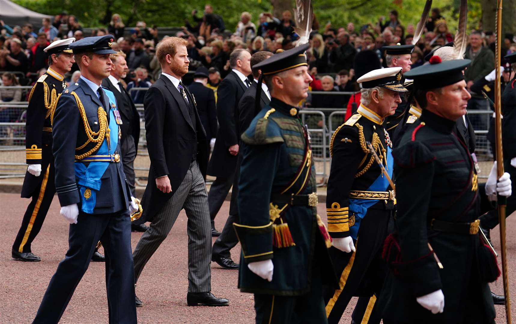 The Prince of Wales, Duke of Sussex and King Charles III walk down The Mall following the Queen’s coffin (Martin Rickett/PA)