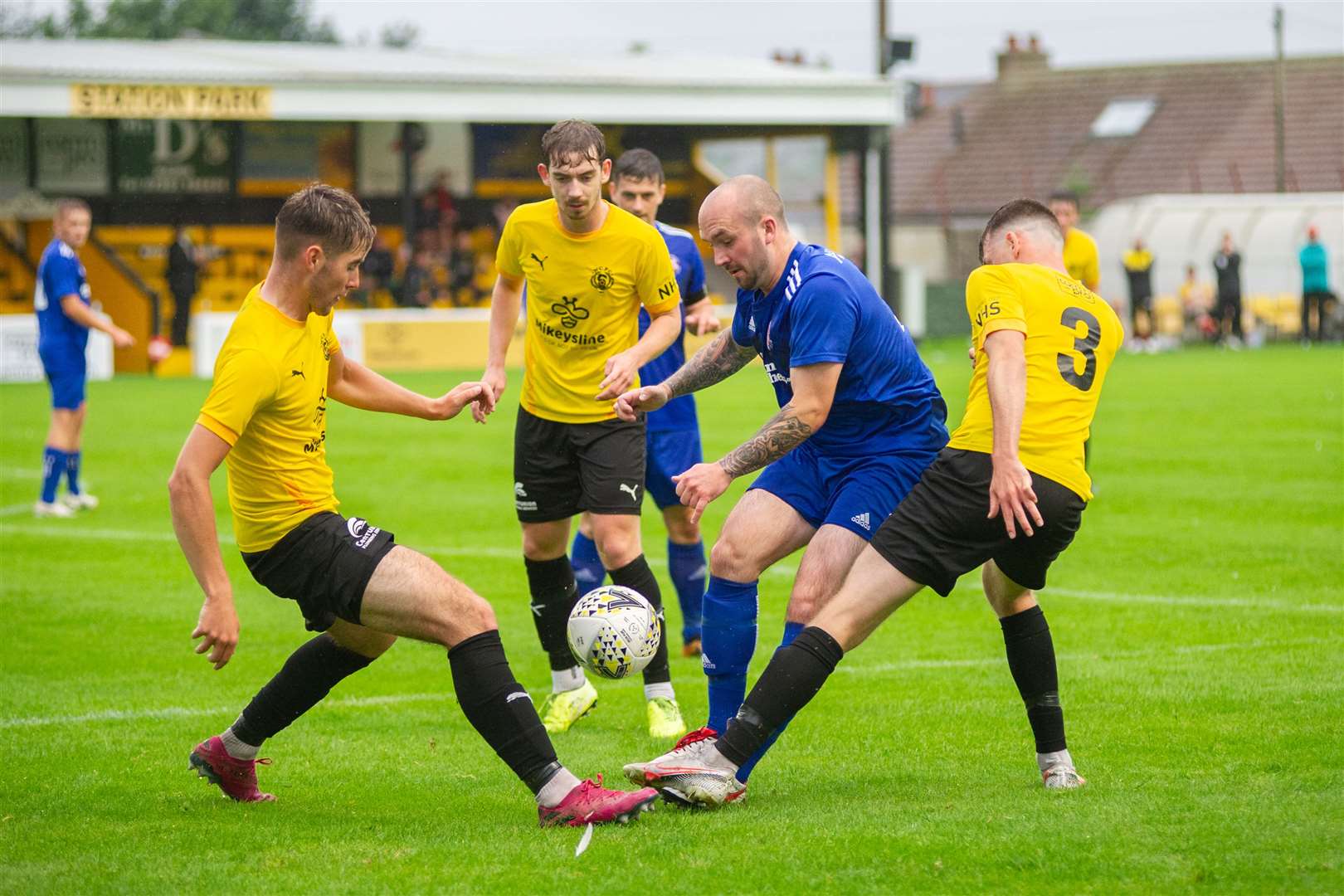 Lossie's Connor Macauley is stuck in a County sandwich...Nairn County FC (2) vs Lossiemouth FC (4) - North of Scotland Cup first round - Station Park, Nairn 28/07/2021...Picture: Daniel Forsyth..