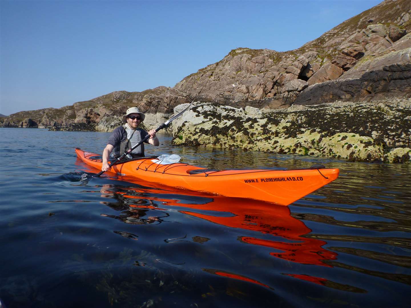 John enjoys flat calm waters as he explores the coastline around the Summer Isles.