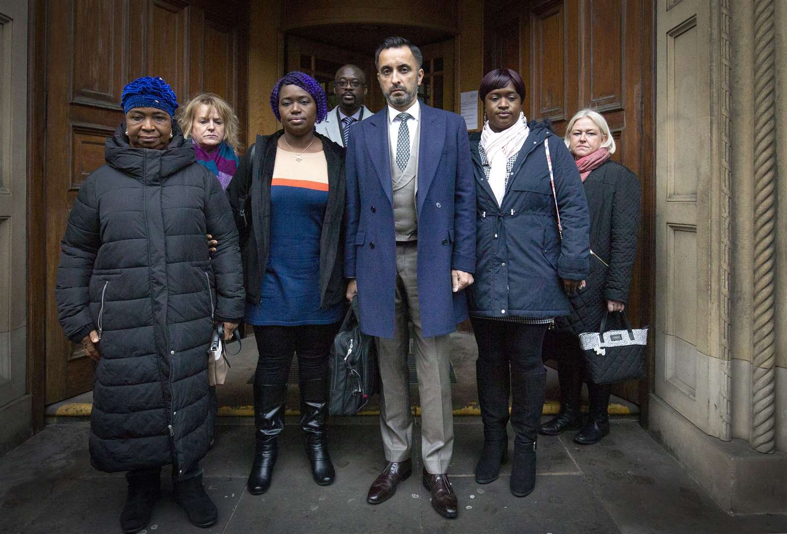 Solicitor Aamer Anwar (centre) arrives outside Crown Office with family members of the late Sheku Bayoh (Jane Barlow/PA)