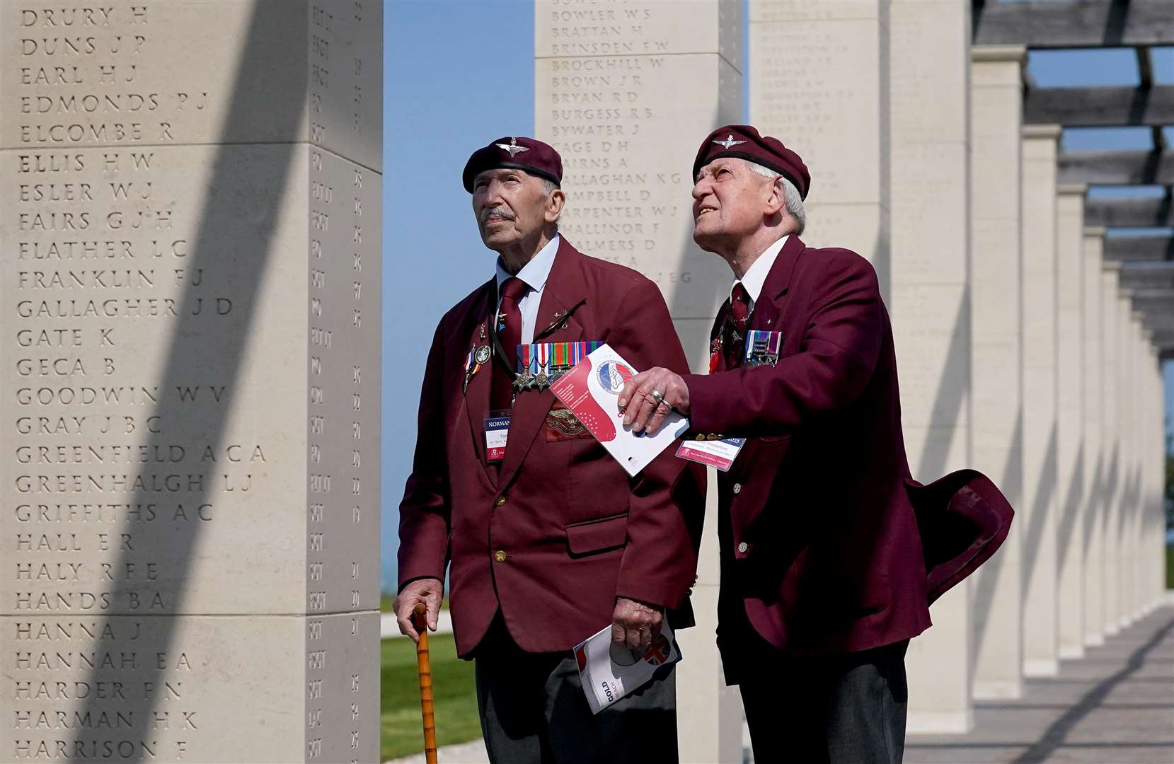D-Day veteran Tom Schaffer, left, and his companion John Pinkerton study the names on the British Normandy Memorial at Ver-sur-Mer in France (PA)