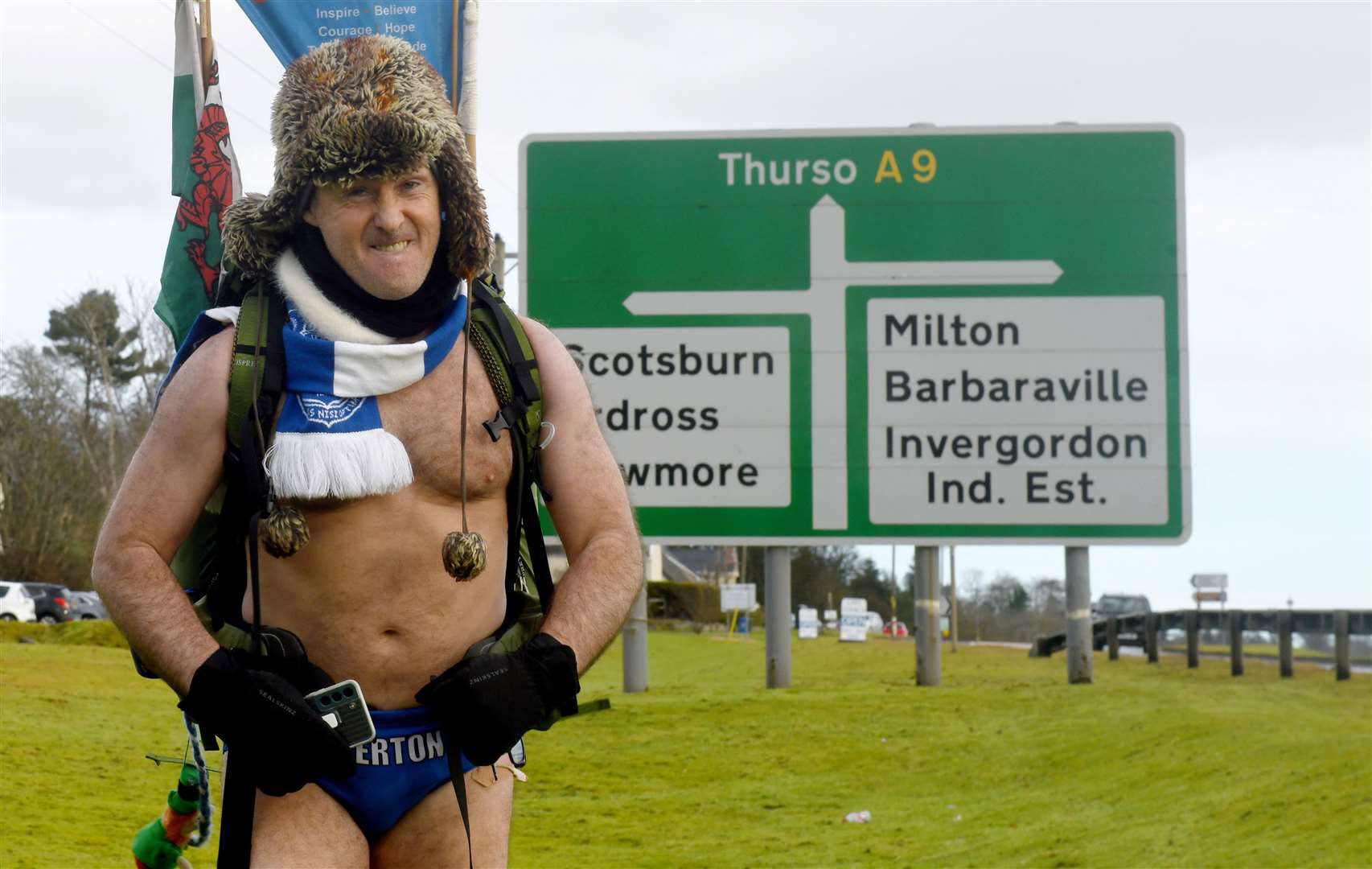 A chilly Speedo Mick passing the sign for the Invergordon junction on the A9. Picture: James Mackenzie