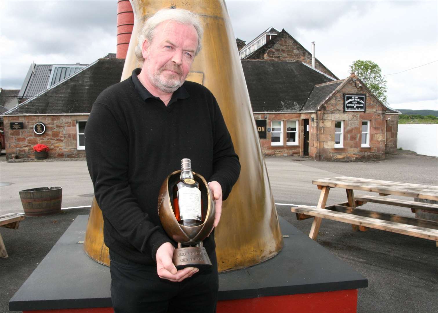 John MacDonald, distillery manager at Balblair Distillery, with the bottle of whisky and its special plinth.