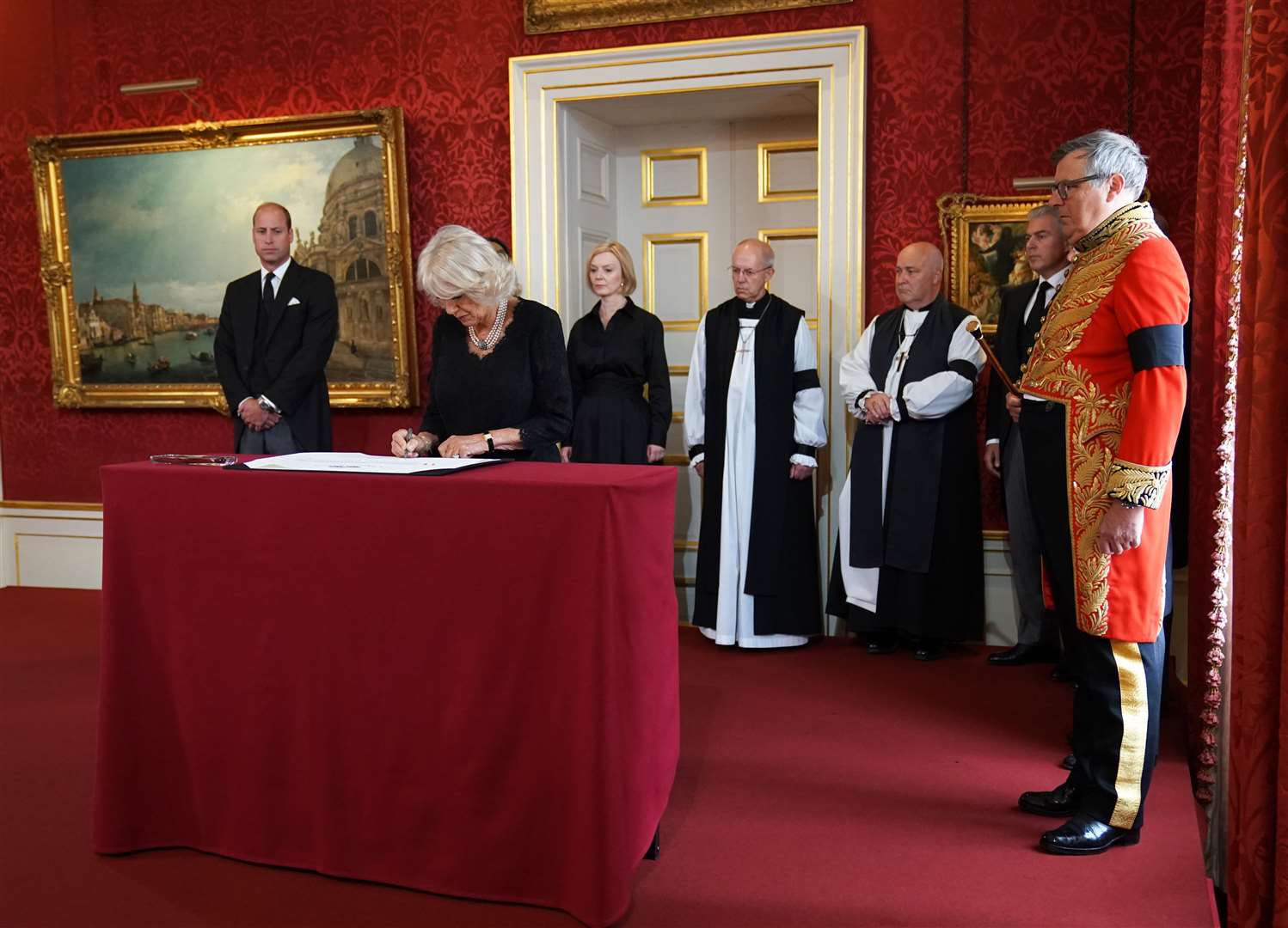 The Queen Consort signs the Proclamation of Accession of King Charles III, watched by (left-right back) the Prince of Wales, Prime Minister Liz Truss , Archbishop of Canterbury, Justin Welby, Archbishop of York, Stephen Cottrell, Lord Chancellor of the Privy Council Brandon Lewis and Earl Marshal, Edward Fitzalan-Howard, the Duke of Norfolk during the Accession Council ceremony at St James’s Palace, London, where King Charles III is formally proclaimed monarchy (Kirsty O’Connor/PA)