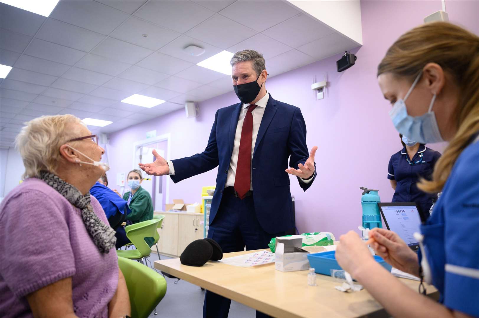 Labour leader Sir Keir Starmer talks to Ruby Byers before she receives the first of two Covid-19 vaccination shots in Stevenage (Leon Neal/PA)