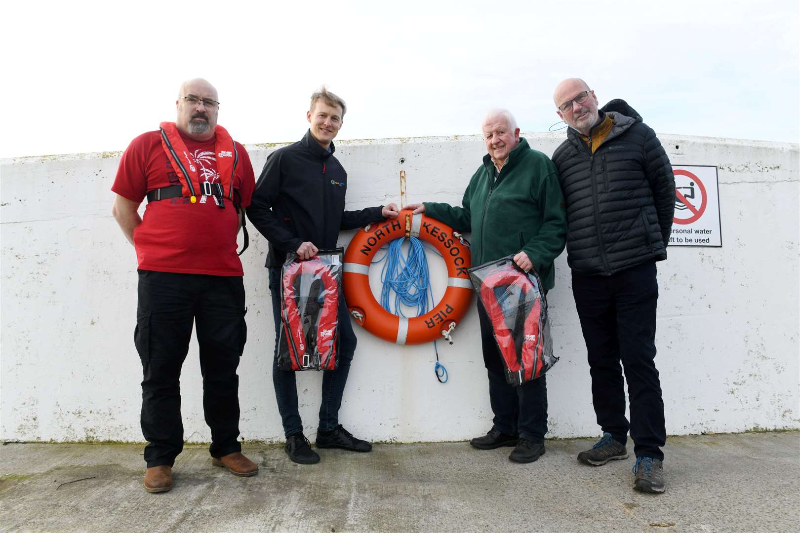 Marc Wilson Gael Force (second left) hands over some life jackets to North Kessock rowing club membersn Paul Shepherd, Keith Brill chairman and David Bowie. Picture: Callum Mackay..