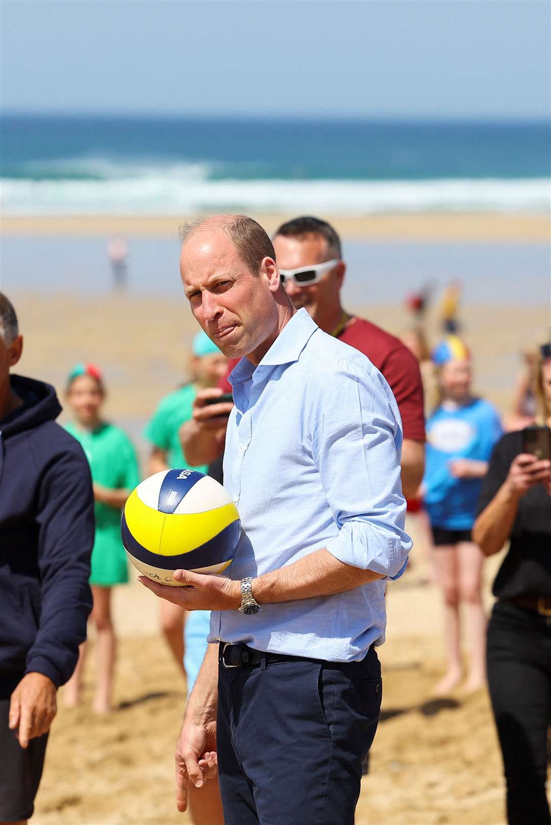 William takes part in a game of volleyball during a visit to Fistral beach in Newquay (Toby Melville/PA)