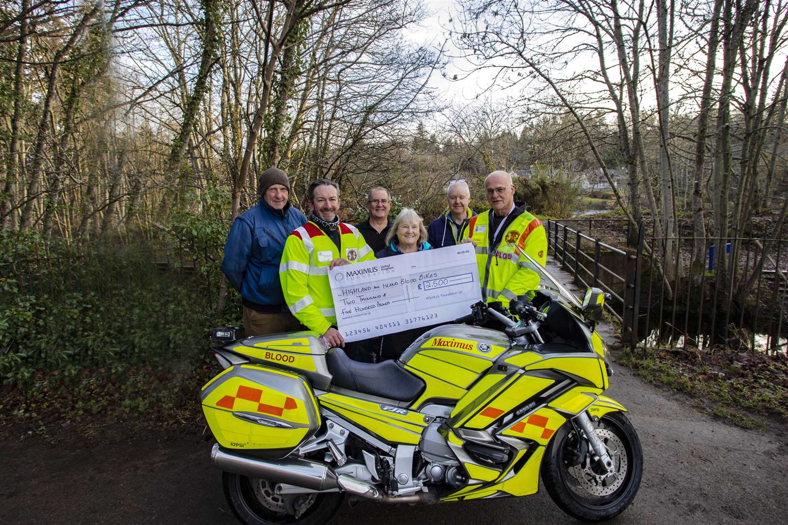 Julie Bradbury, of the Maximus Foundation, hands over £2500 to Highlands and Islands Blood Bikes.