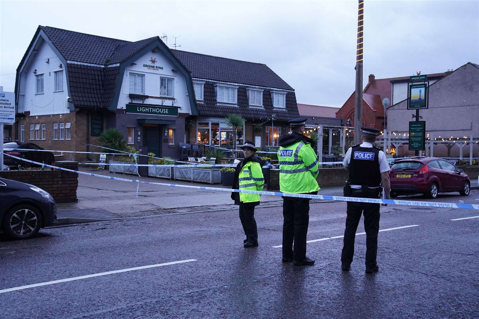 Police officers guarding the scene of the killing at the Lighthouse Inn (Peter Byrne/PA)