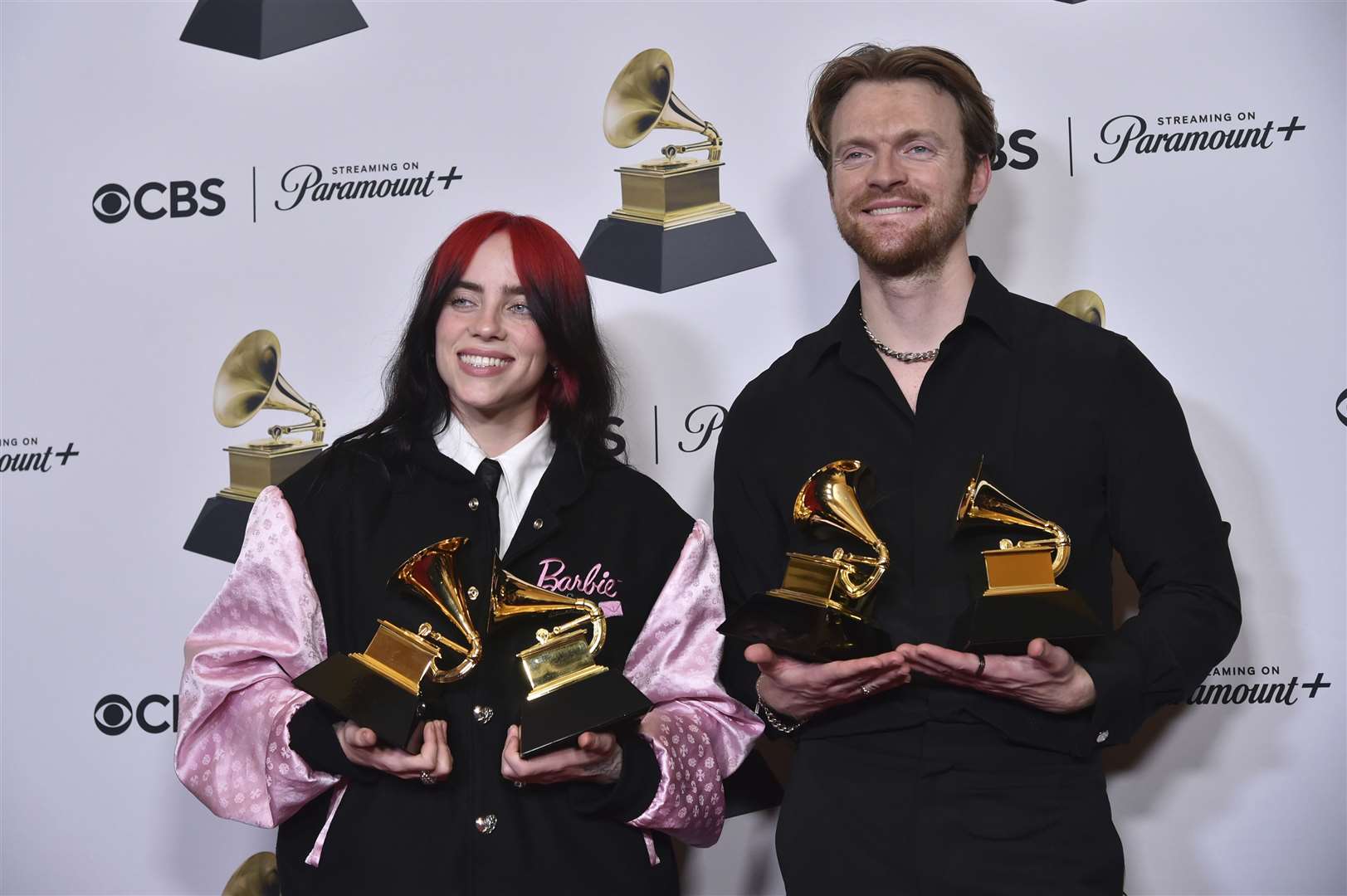 Billie Eilish and Finneas O’Connell celebrate with their awards for best song written for visual media and song of the year for What Was I Made For? from Barbie the Album (Richard Shotwell/Invision/AP)
