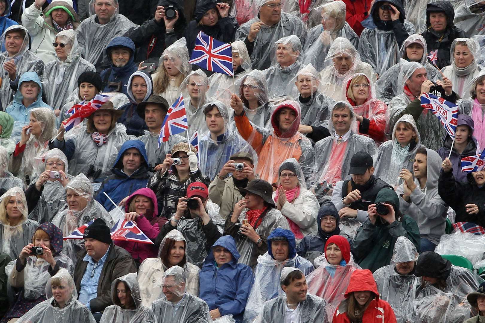 Well wishers watch the Diamond Jubilee River Pageant in the rain (Dan Kitwood/PA)