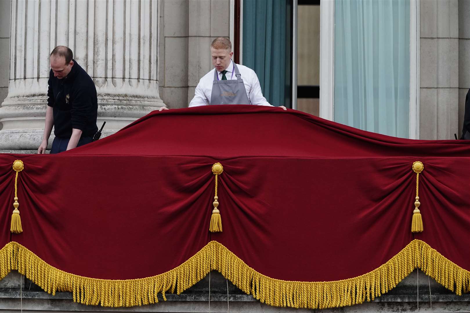 Staff of the royal household made final preparations on the balcony of Buckingham Palace (Jordan Pettitt/PA)