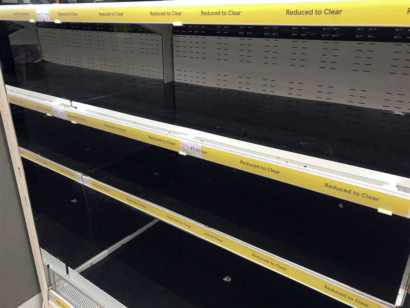 Empty shelves in the reduced to clear aisle at the Portsmouth North Harbour Tesco on Monday (Steve Parsons/PA)