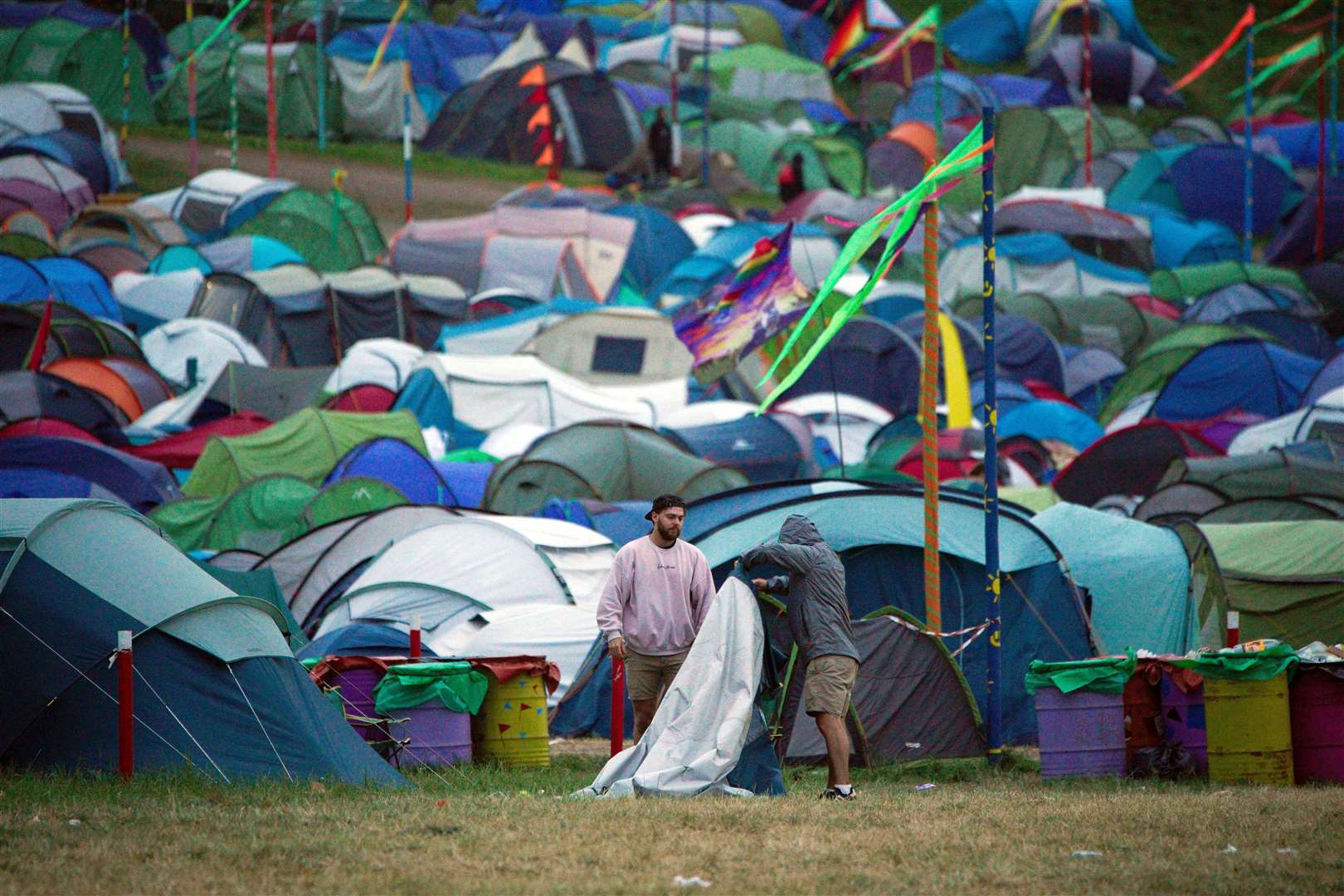 Festival-goers pack away a tent (Ben Birchall/PA)