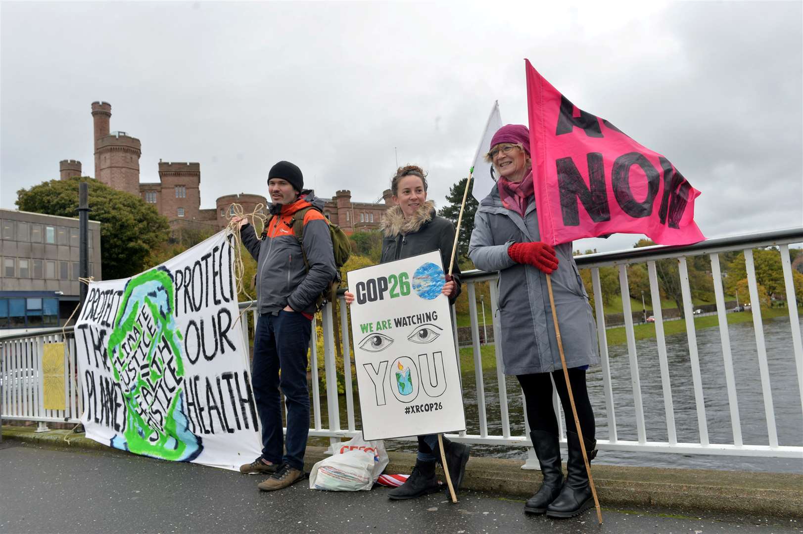 Lawrence Castle, Abi Johnston and Kate Maclachlan with some banners on Ness Bridge yesterday.