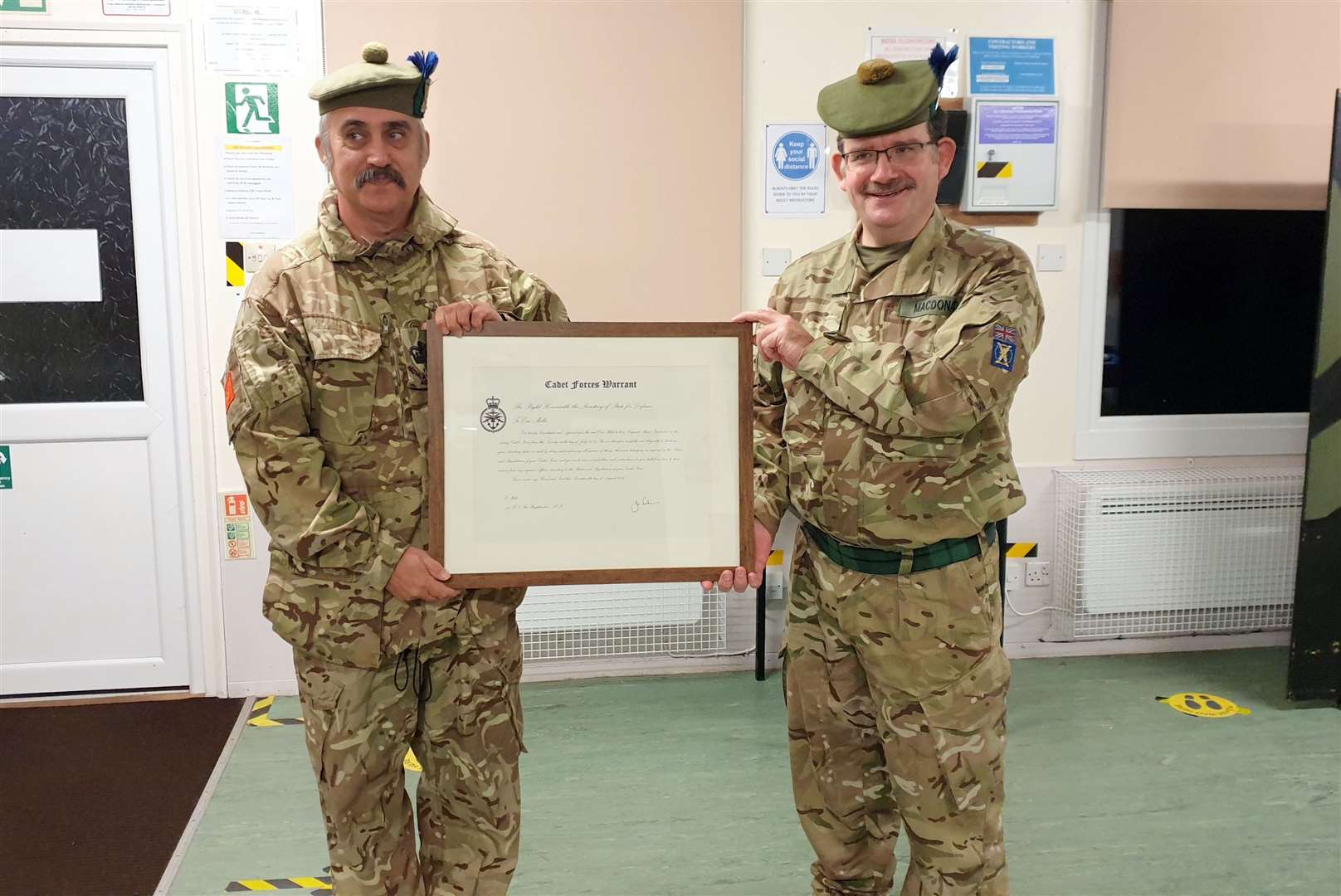 SMI Mills being presented with the Cadet Force warrant by the Battalion's Commandant Col McDonald
