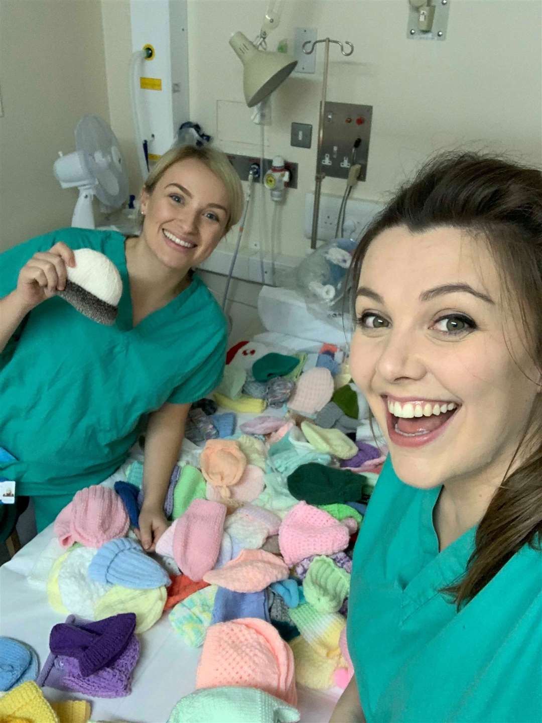 Student midwife Mairead McPhee and staff midwife Mairi MacKenzie sorting through the hats.