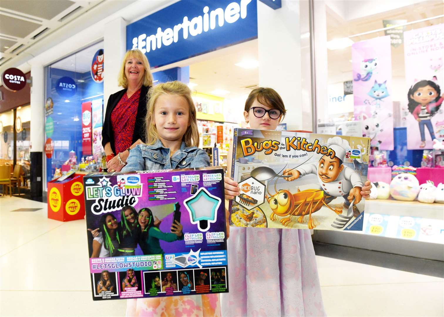 Jackie Cuddy, Eastgate Shopping Centre manager, presents prizes to Stella Robertson (7), of Inverness, and Miya Fraser (8), of Inverness.