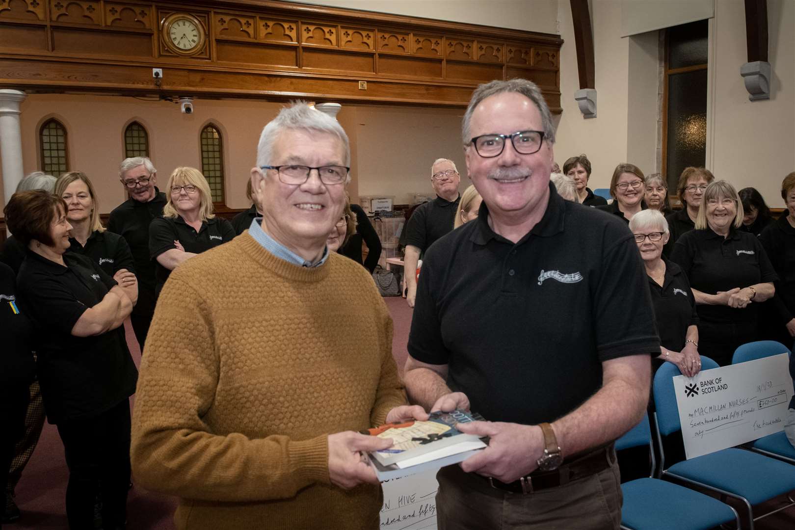 Donald Wilson receives a gift from Ian Bryce Chairman of Accidentals Choir. Picture: Callum Mackay..